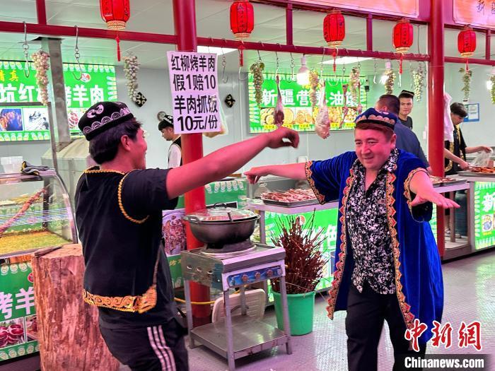 圖為餐飲經營者在“西涼不夜城”跳起舞蹈引客。　戴文昌 攝</p><p>